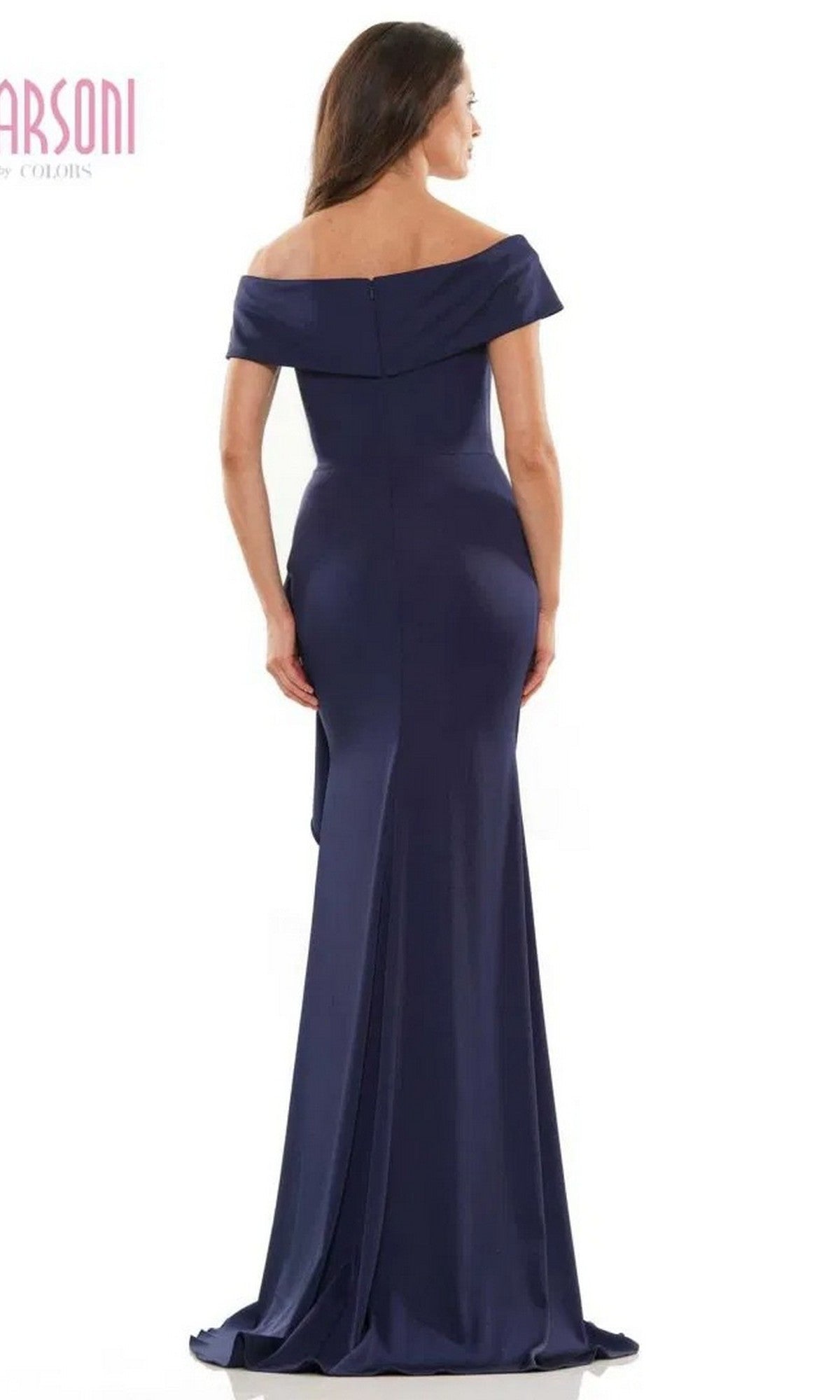 A woman models the Marsoni MV1180 long formal dress, an off-the-shoulder navy blue gown with a beaded waistline, shown from the back against a plain white background.